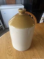 Front view of lighter beige body flagon with brown glazed top
