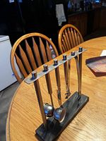 Front view of rack with all five tools on marble base