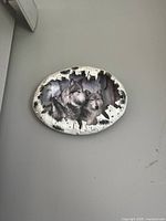 Front view showing wolf artwork and birch-bark rim