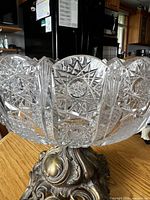 Side view showing cut crystal bowl and brass base
