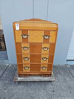 Full front view of Art Deco highboy dresser on dolly
