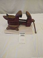 Full view of red Columbian bench vise on swivel base