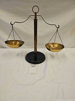 Full view of brass balance scale showing both pans and base