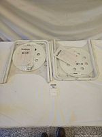 Two packages each containing seat panel, legs, instructions and hardware