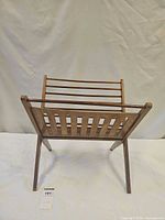 Front view of wooden folding magazine rack standing open