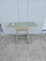 Full view of metal typewriter table with leaves extended