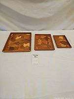 Front view of three Mori Kougei marquetry wood trays graduated in size