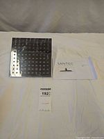 Shower head with manual and paperwork laid out