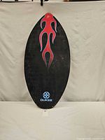 Full front view of Dukes skimboard showing flame graphic and overall wear