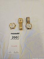 Three Disney watches laid out showing cases and bands