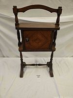 full view of wooden smoker's stand showing door and legs