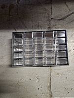 Front view showing all 30 clear drawers in gray metal housing