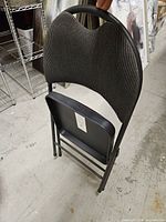 Chair folded showing backrest pattern and frame