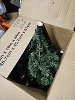 Tree sections inside original cardboard box