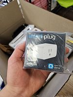 Front of sealed Amazon Smart Plug box showing product image and Alexa compatibility