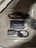 Tray containing Anyfar adapter dongle plus two short cables
