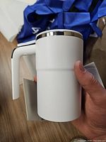 white automatic stirring cup side view with handle