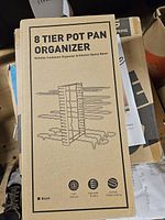 Front of boxed 8-tier pot pan organizer showing product image and key features