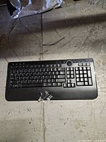 Top view of Dell wireless keyboard with dongle positioned on palm rest