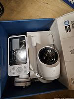 Open box showing parent monitor, camera unit and accessories
