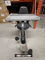 Front view showing desk surface, seat, pedals