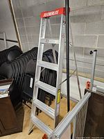 Full view of Featherlite aluminum 6 ft step ladder showing five steps and red top cap
