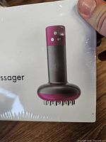 Front of sealed box showing massager image