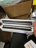 Vacuum sealer opened showing internal sealing bars