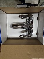 Top view of chrome faucet inside box
