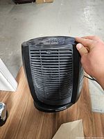 Front view of black Honeywell heater showing grill and base