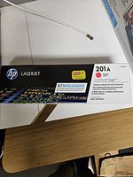 Front of HP 201A CF403A retail box showing branding and magenta color indicator