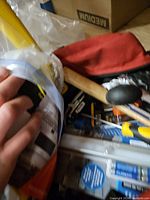 Open Husky bag showing mallet handle, screwdriver, packaged items