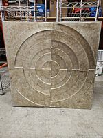 Front view of square beige and gold concentric circle canvas wall art