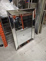 Front view showing beveled mirrored frame and overall design