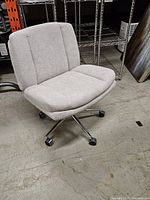 Front angle showing full chair, upholstery, chrome base and casters