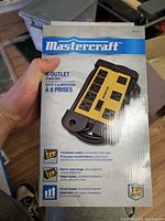 Front of sealed box showing Mastercraft 8-outlet power strip image and branding