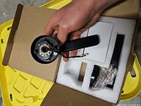 Open box showing interior lever handle with wires and other components in foam