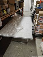 Overall view of laminate dining table still wrapped