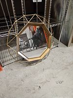 Front view showing octagonal mirror and gold wire frame