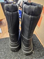 Rear view of both boots showing height, padded collar, outsole