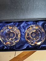 Both crystal ashtrays seated in blue satin-lined box showing double-happiness etching
