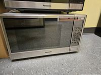 Front view of Panasonic stainless steel microwave showing door and control panel
