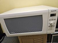 Front view of Panasonic white microwave closed