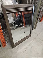 Front view showing rectangular mirror and grooved wooden frame