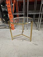 Full view of round glass side table showing frame and top