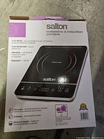Retail box front showing Salton portable induction cooktop image and specs