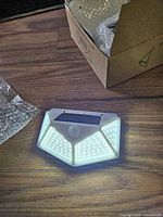 One light illuminated showing LED arrays, solar panel, sensor