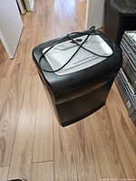 Full view of black and silver Staples shredder with cord