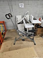 Full side view of hydraulic rowing machine on storage floor