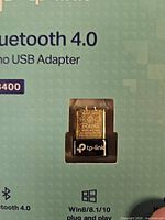 Front of TP-Link UB400 retail box showing adapter and key specs